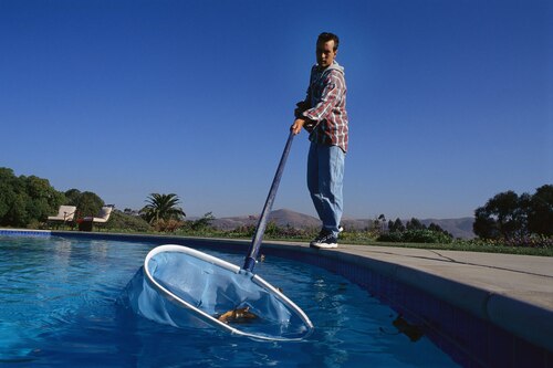 Man fishing garbage out of pool